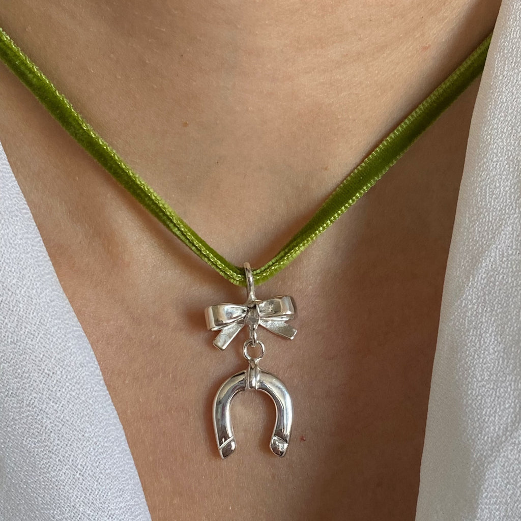 bow and horseshoe necklace